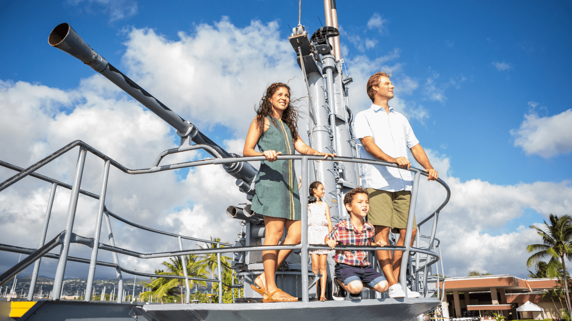 Family looks out from Bowfin deck gun Family looks out from Bowfin deck gun