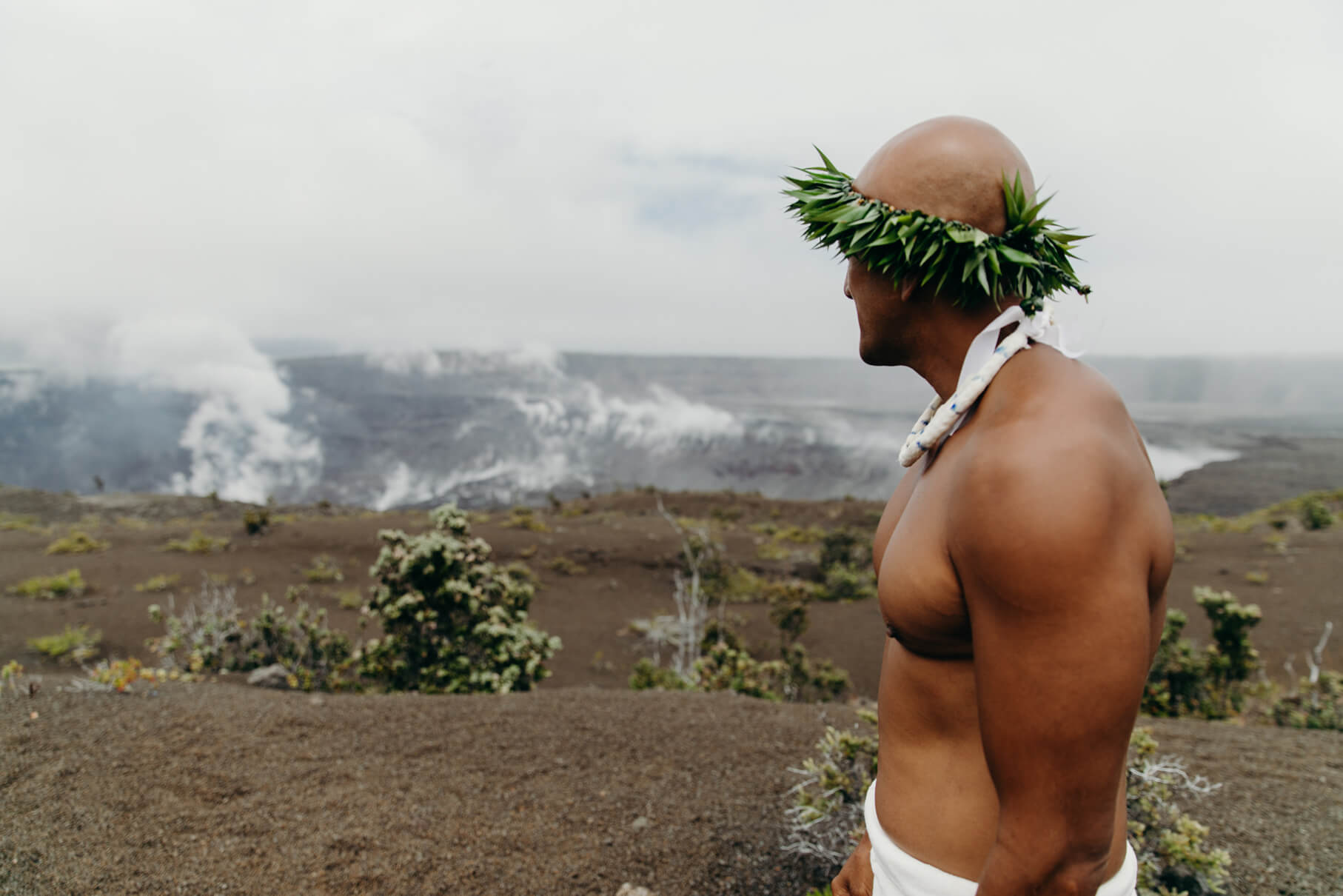 Cultural practitioner looks across Halemaumau Crater