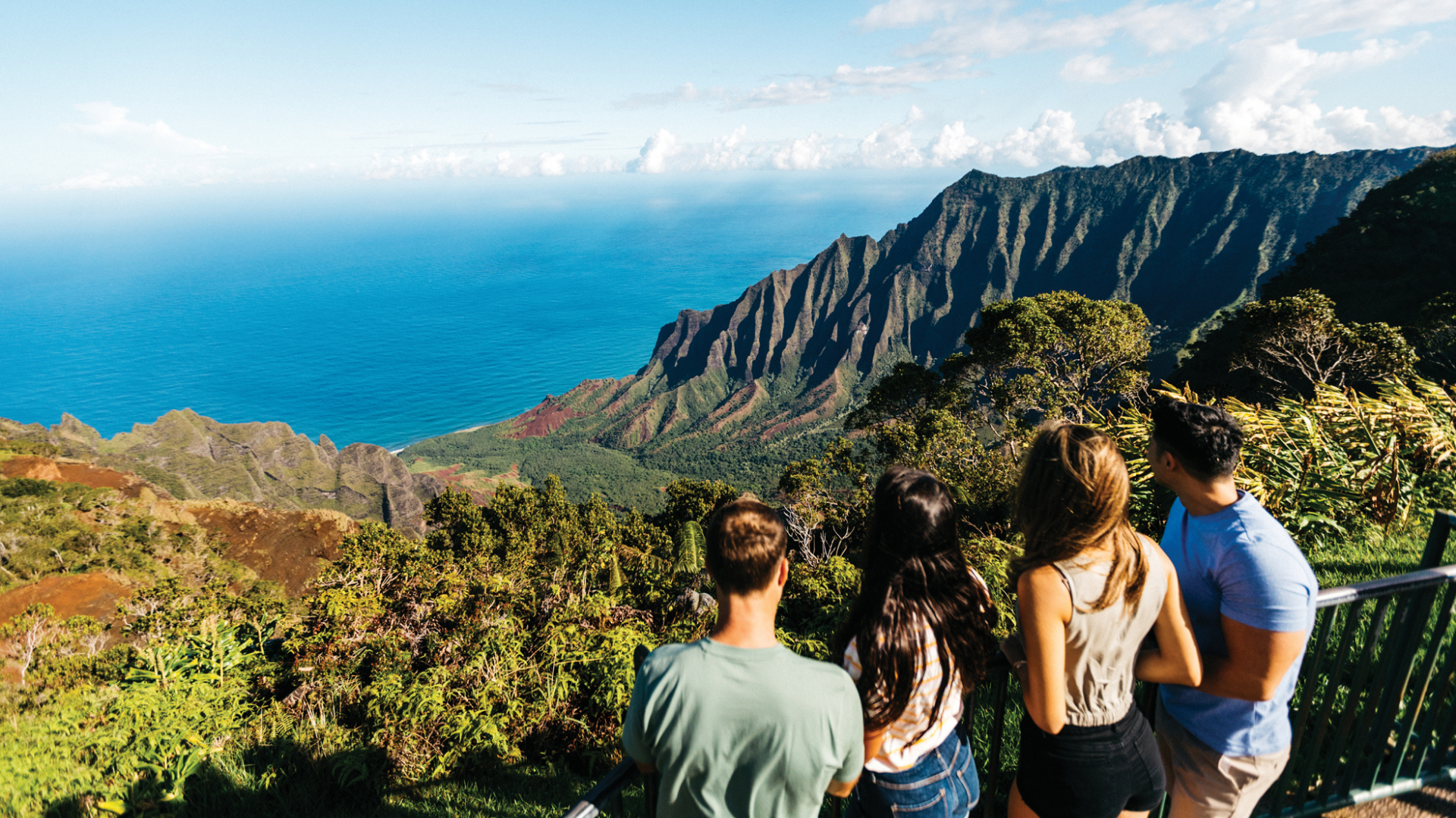 People enjoy the breathtaking view from Kalalau Lookout People enjoy the breathtaking view from Kalalau Lookout