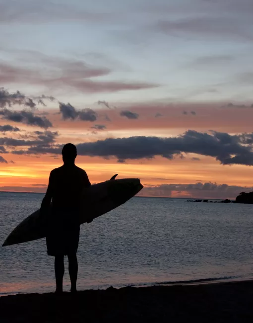 Surfing at sunset on Maui