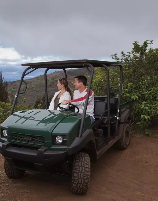A couple driving a jeep on Lanai