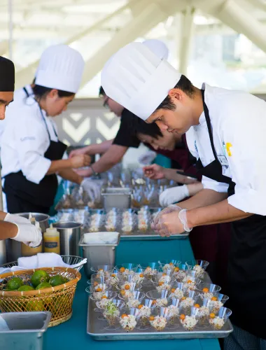 Chefs preparing food during the Hawaiʻi Food and Wine Festival on Oʻahu 