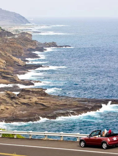 Car driving along coastline