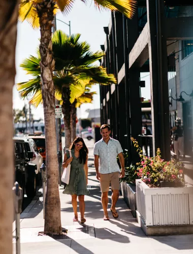 People walk through an outdoor shopping center