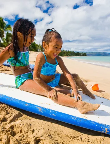 Kids playing on surfboard
