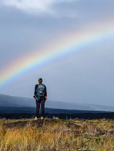 Man in field with rainbow Hawaii