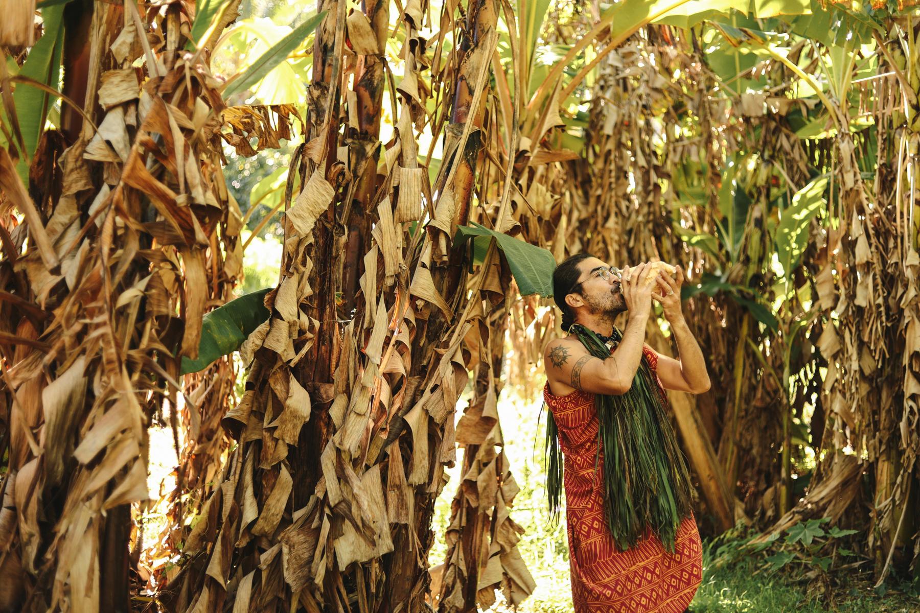 Traditions - Man blowing conch shell