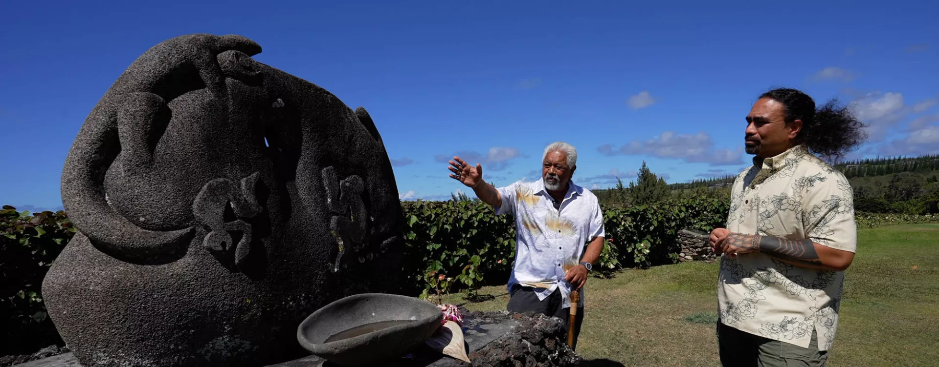 Clifford Naeole pointing to statue on Maui, Hawaii