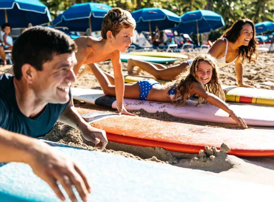Family taking a surfing lesson on Waikīkī Beach in Honolulu, Oʻahu, Hawaiʻi