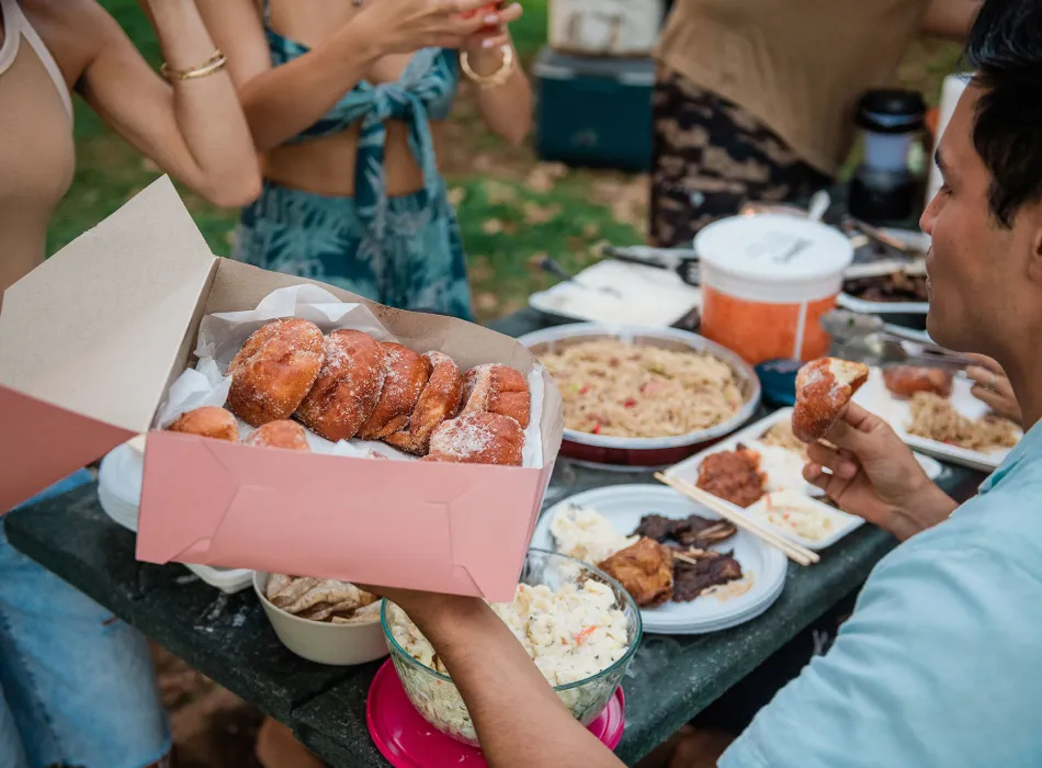 Group having a potluck lunch at Ala Moana Regional Park on Oʻahu in Hawaiʻi