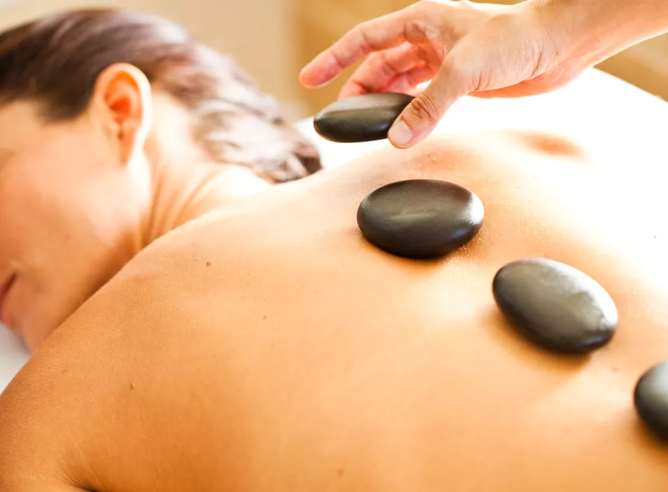 Woman enjoys a hot stone massage in Maui