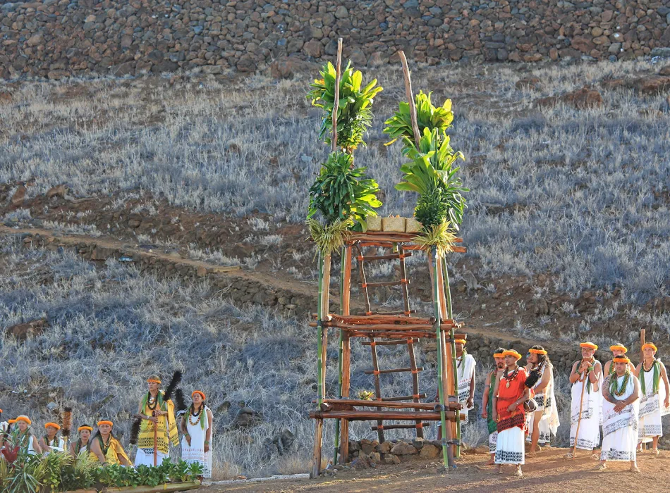 Cultural ceremony at Puukohola Heiau with participants in traditional attire.