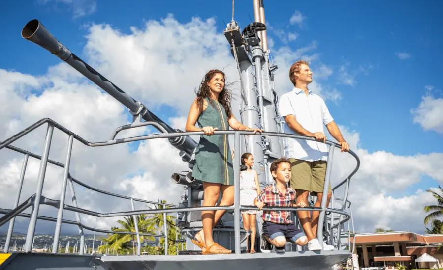 Family looks out from Bowfin deck gun