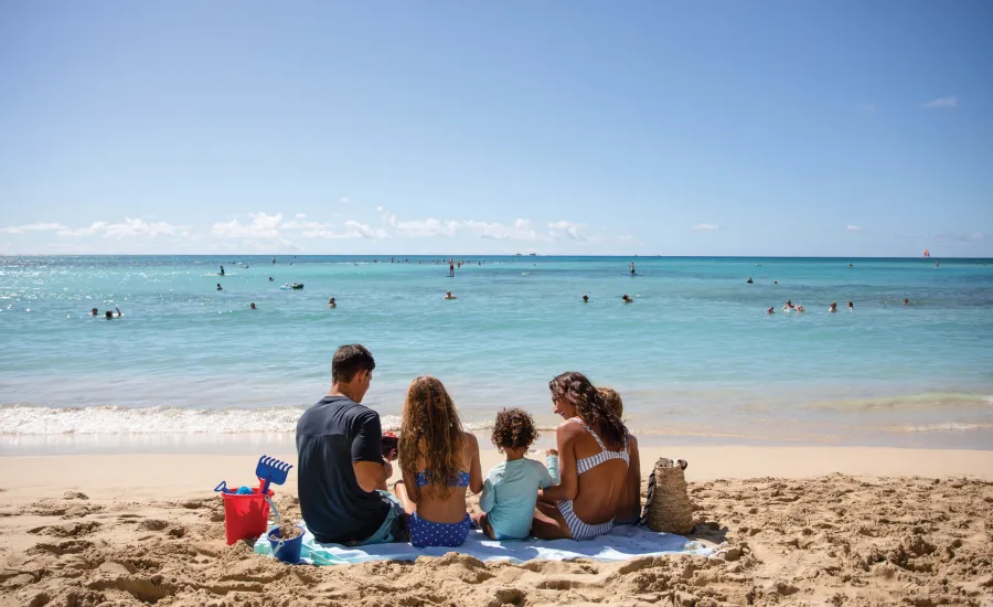 Family with young children enjoying the beach