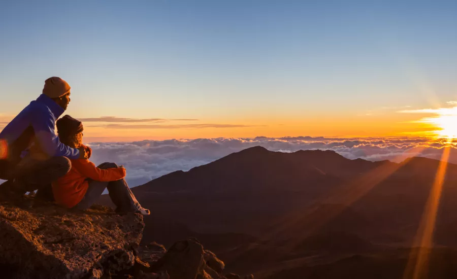 Couple watch the sun rise atop Haleakala