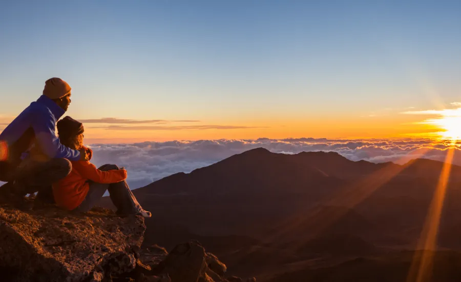 Couple watch the sun rise atop Haleakala