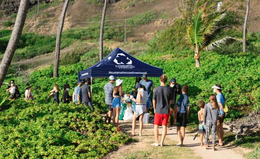 Volunteers wearing face masks at a beach cleanup for Sustainable Coastlines Hawaii