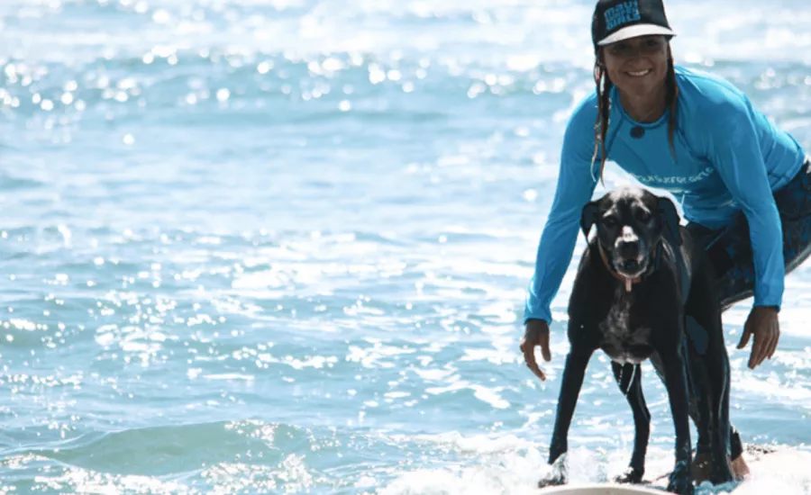 Dustin Tester surfing with her dog