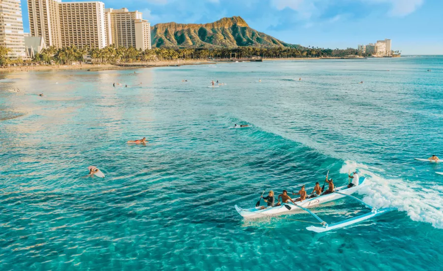 Catching a wave on an outrigger canoe